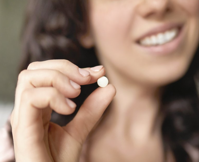 Woman Holding Toothpaste Tablets Mint flavour with Fluoride Turtle Tribe